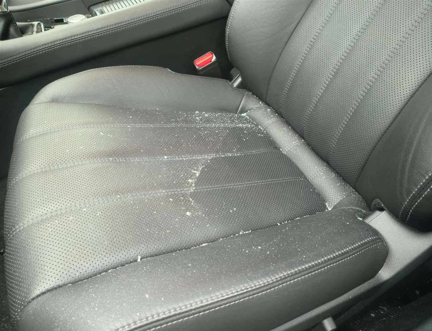 The windscreen didn’t break, but shards of glass scattered the passenger seat. Picture: Ben Lindley