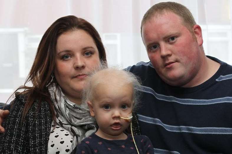 Ruby Young, two, with parents Vikki and Rob