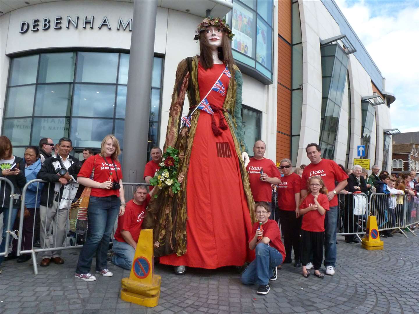 Flora the Singleton Giant with members of the Singleton Giant Association outside Debenhams in Ashford