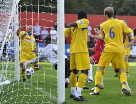 Ben Martin bundles home the opening goal for Welling United against Woking.