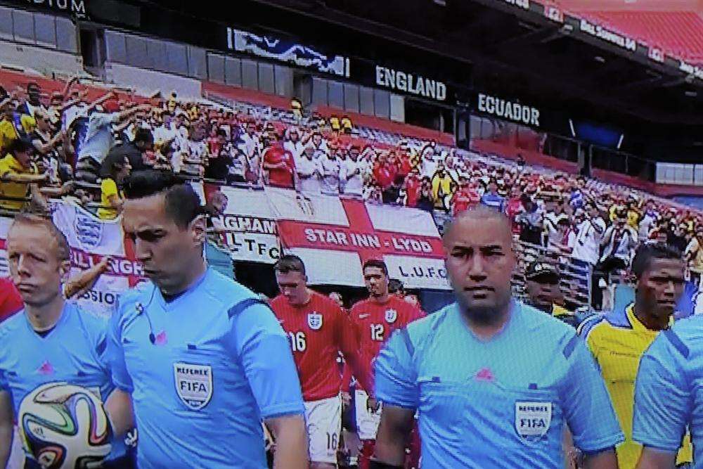 The Marsh greets the globe. Supporters with a Lydd banner during a World Cup warm-up.