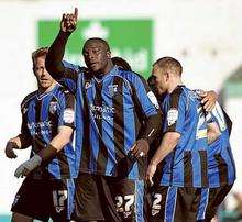 Adebayo Akinfenwa celebrates scoring Gillingham's fourth goal against Lincoln