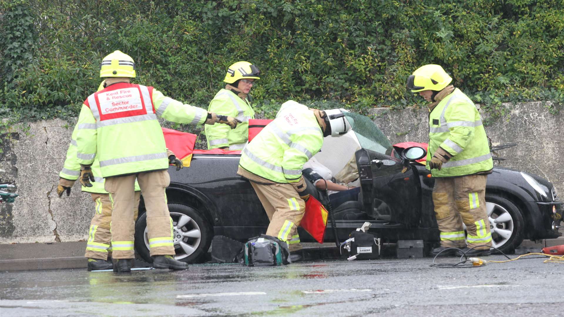 Firefighters work to free a girl from one of the cars hit