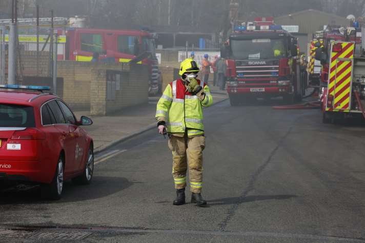 Firefighters wear breathing equipment