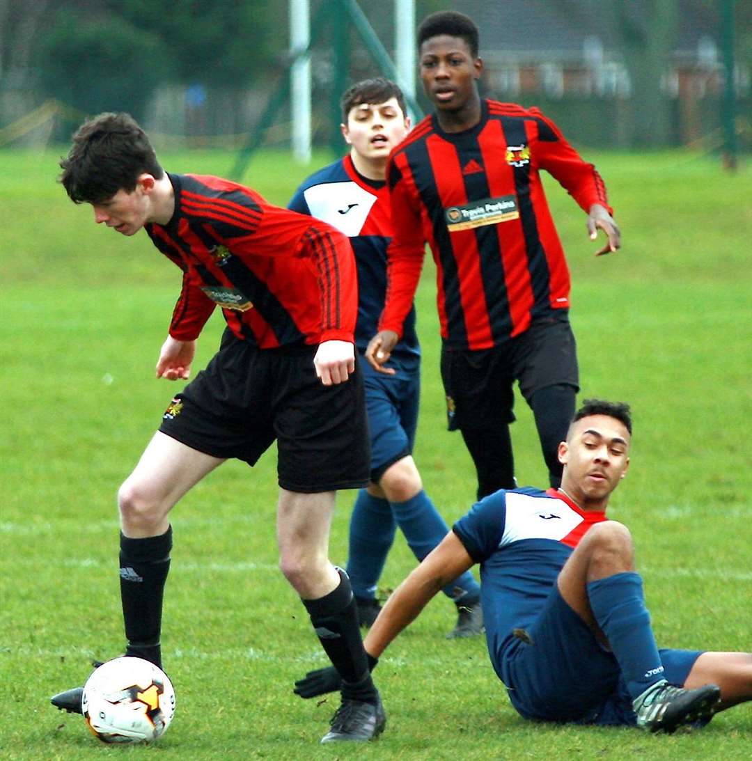 Woodcoombe Youth (stripes) battle it out with Hempstead Valley in Under-18 Division 1 Picture: Phil Lee