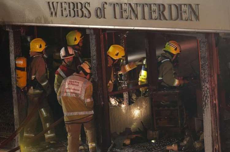 Firefighters wearing breathing equipment enter Webbs of Tenderden. Picture: Stafford@redbookphotography