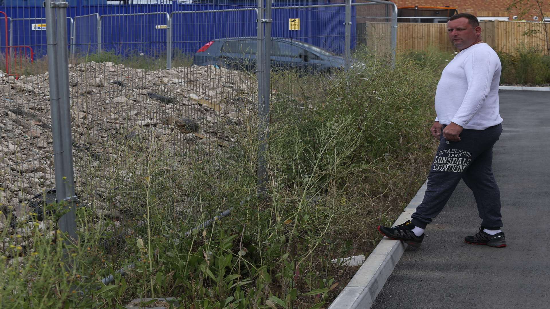 Tom Pexton stands next to an area of weeds and overgrown plants near his new home. Picture: John Westhrop FM4834316