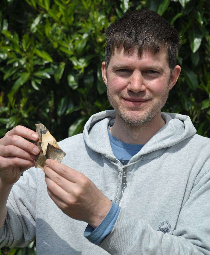 Dr Francis Wenban-Smith and one of the Neanderthal flint tools discovered in Swansombe. Photo: Oxford Archaeology and the University of Southampton