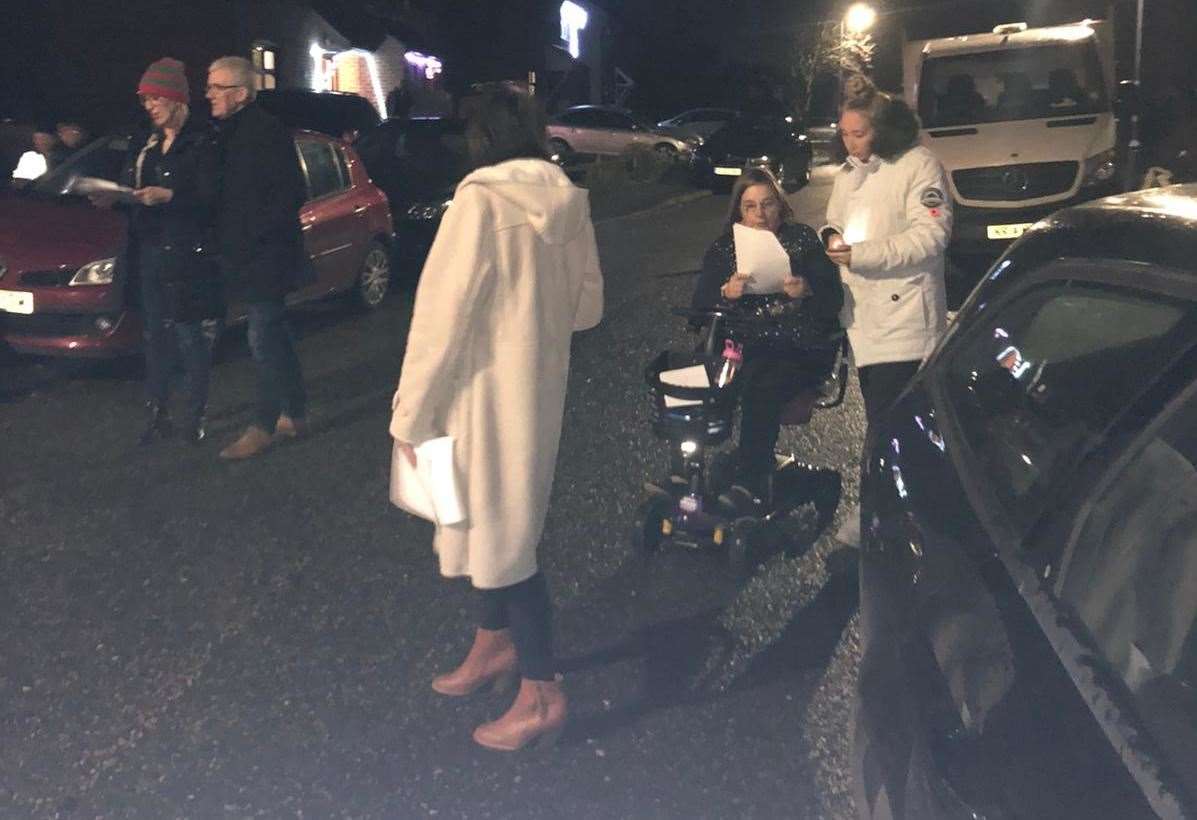 People gathered in Camden Close, at a distance, to recite the Christmas carol classic, We Three Kings. Picture: Verity Robinson