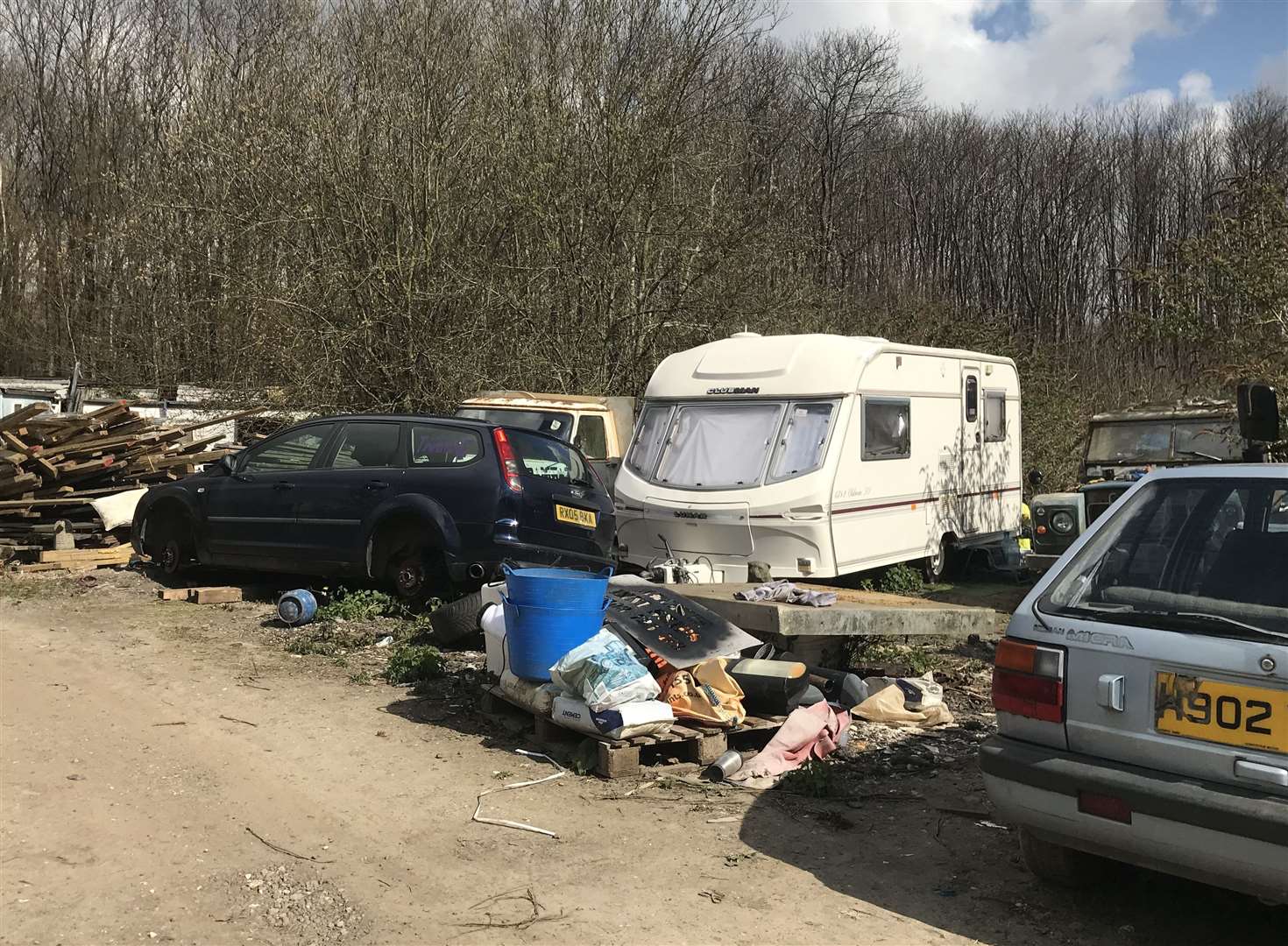 The former area of woodland, which is in an Area of Outstanding Natural Beauty has been used to store waste and vehicles