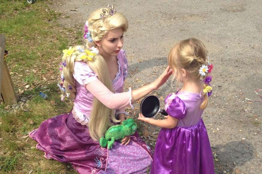 Violet Armstrong, three, collects a prize for her costume