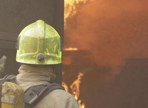 Firefighter tackling a blaze. Stock photo.