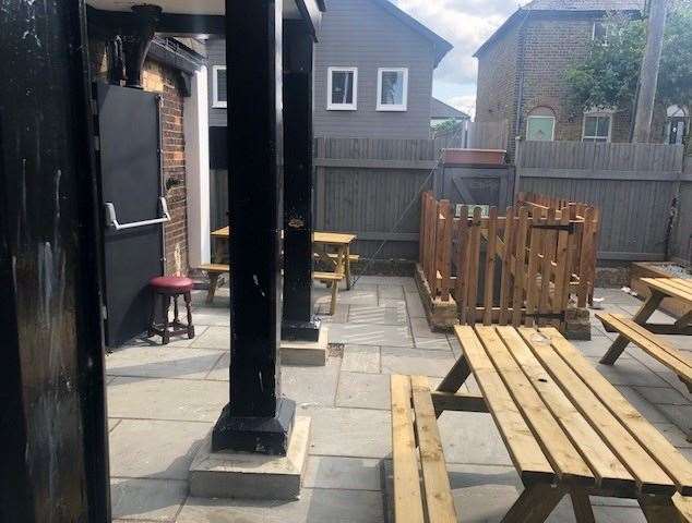 The paved outdoor area, with a number of picnic tables, looked new and neat, as if it had recently benefitted a makeover