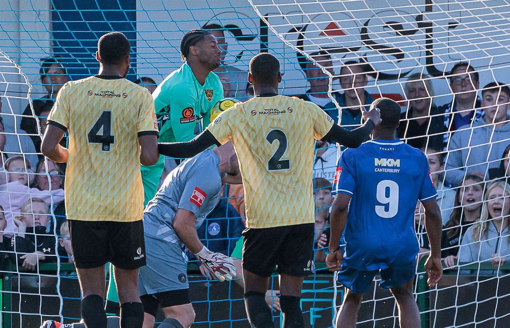 Herne Bay goalkeeper Harry Brooks is just denied a dramatic late leveller by counterpart Alexis Andre Jr during a goalmouth melee. Picture: Helen Cooper