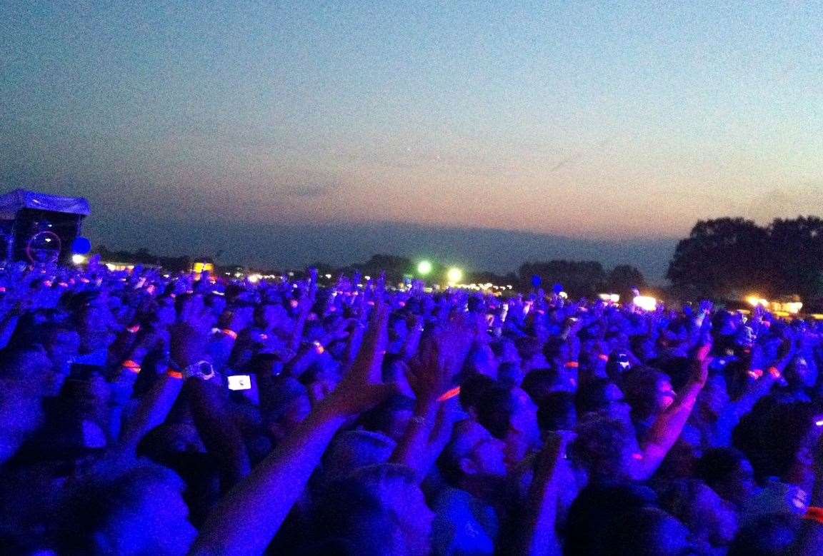 The sun sets as Purple Rain bathes the crowd in the star's trademark colour