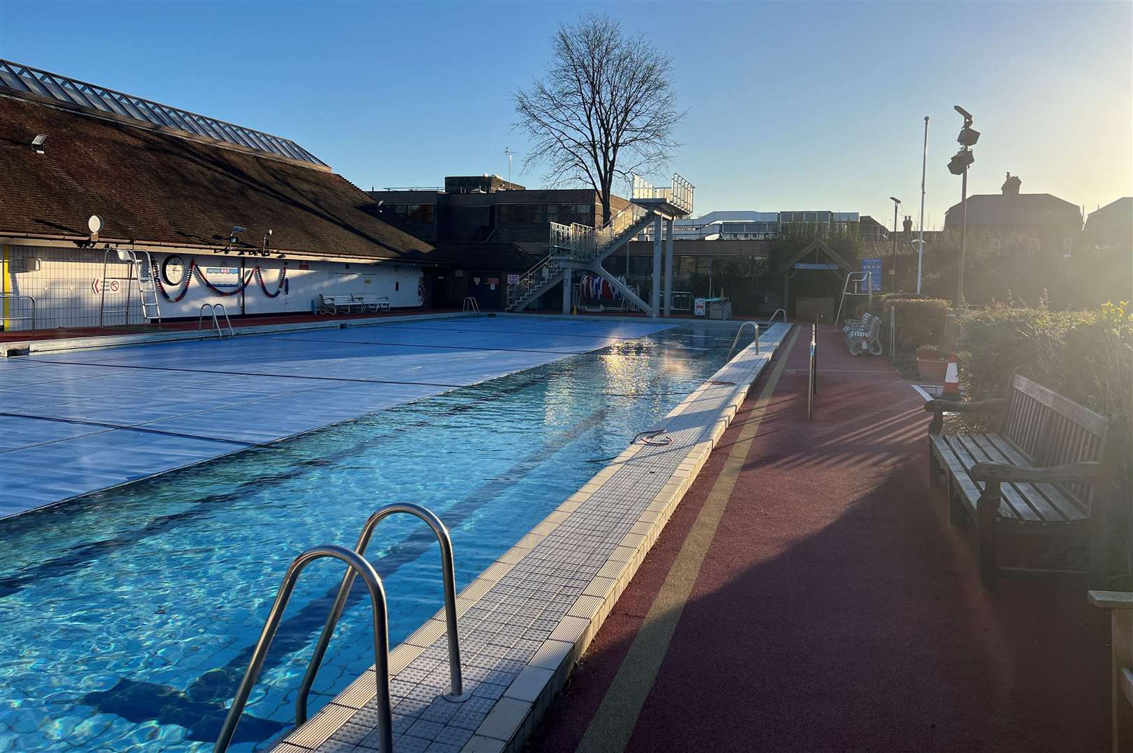 Faversham Pools' outdoor pool having its covers removed. Picture: Megan Carr