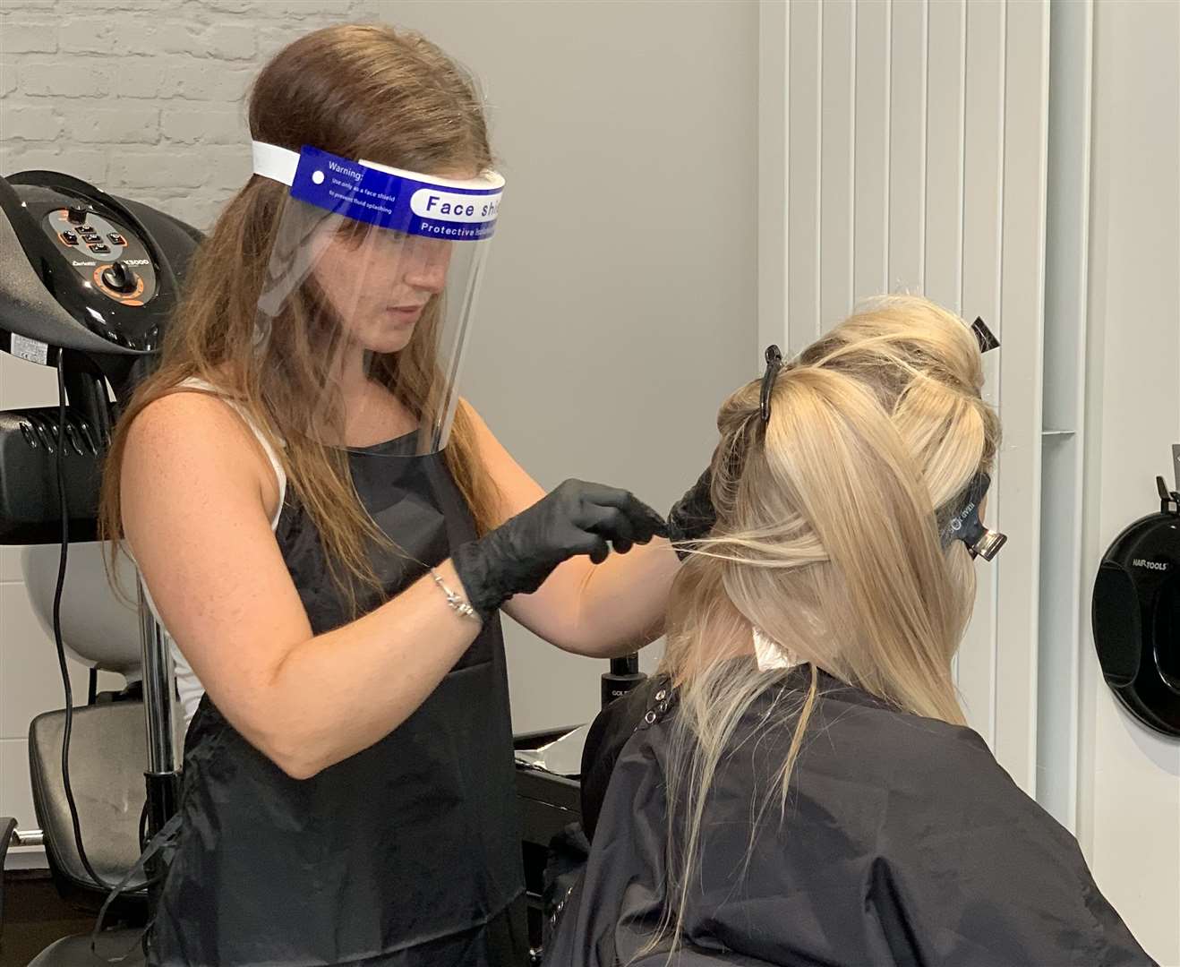 Hair stylist Lilly from JM Hairdressing in Gravesend training in her PPE. Picture: JM Hairdressing