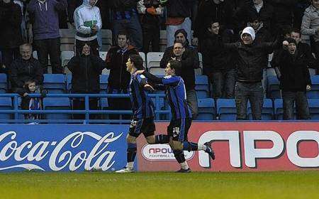 Cody McDonald celebrates his second goal in front of the Rainham End against Aldershot