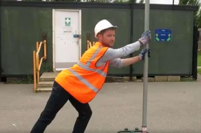 Mr Denney with the netball post