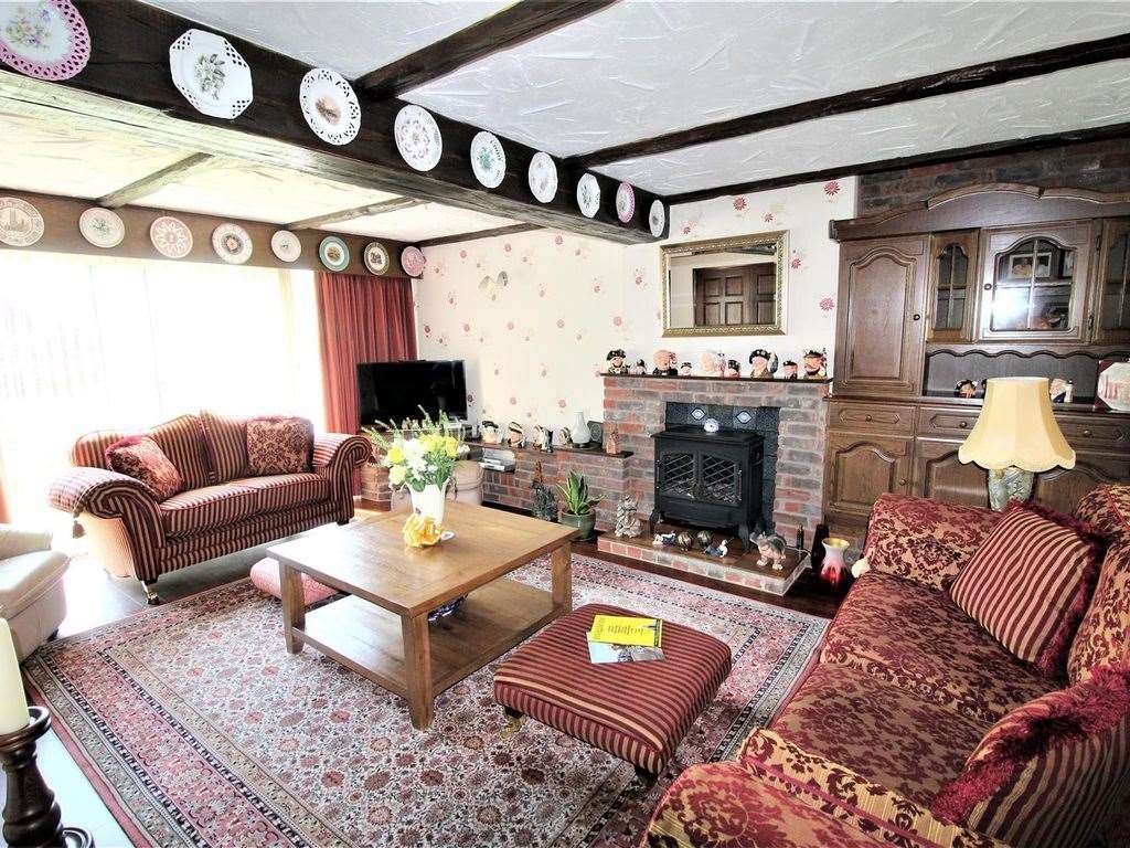 Beams and dark wood panelling give the sitting room an old-fashioned, cosy feel. Photo: Zoopla