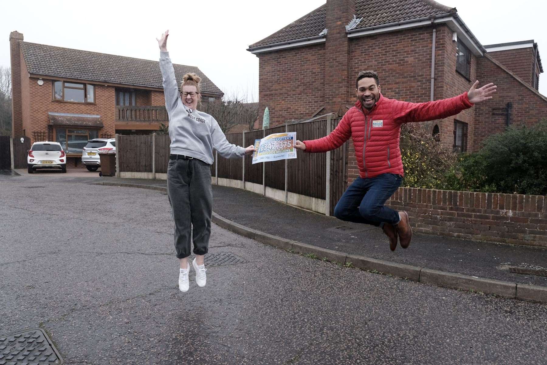 Jodi Johnson with singer Danyl Johnson presenting the winners with their cheque. Picture: People's Postcode Lottery