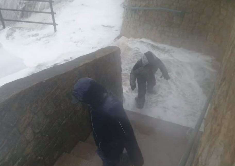 The boy quickly climbs to his feet and follows the youngster up some steps, closely followed by a man, believed to be their dad