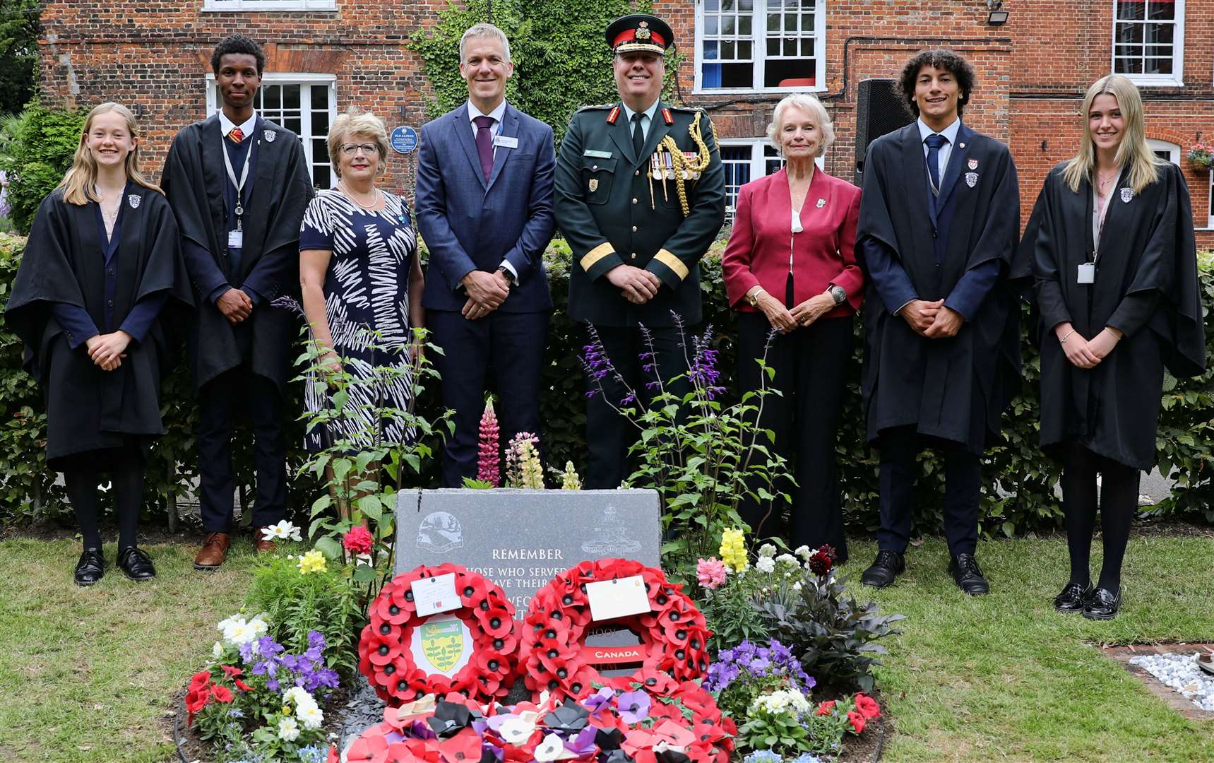 Gnr Pike's niece Vicki Colborne (third left), school head Michael Hall (centre left), Brig Gen Dwayne Parsons - representing the Canadian Armed Forces in the UK - and Judith Holloway are flanked by the school captains and their deputies