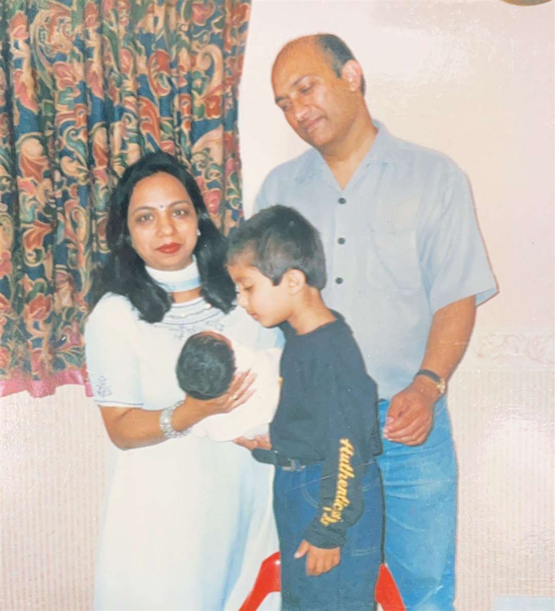 My mum, dad and brother with newborn me