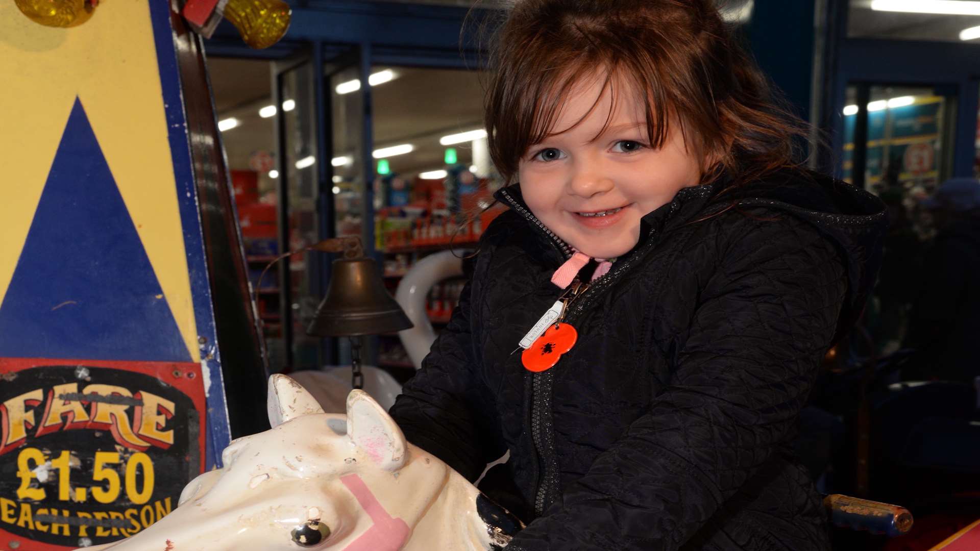 Poppy Setterfield, four, enjoying a ride on the carousel