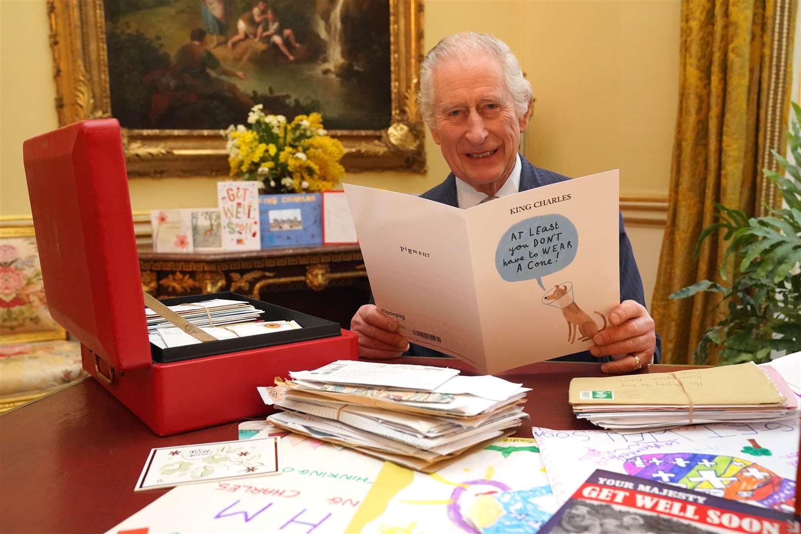 The King reads cards and messages, sent by well-wishers (Jonathan Brady/PA)