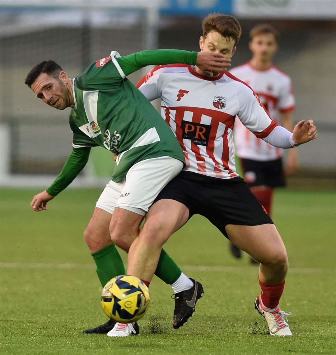 Ashford goalscorer Ian Draycott challenges ex-Nuts & Bolts man Josh Wisson. Picture: Ian Scammell