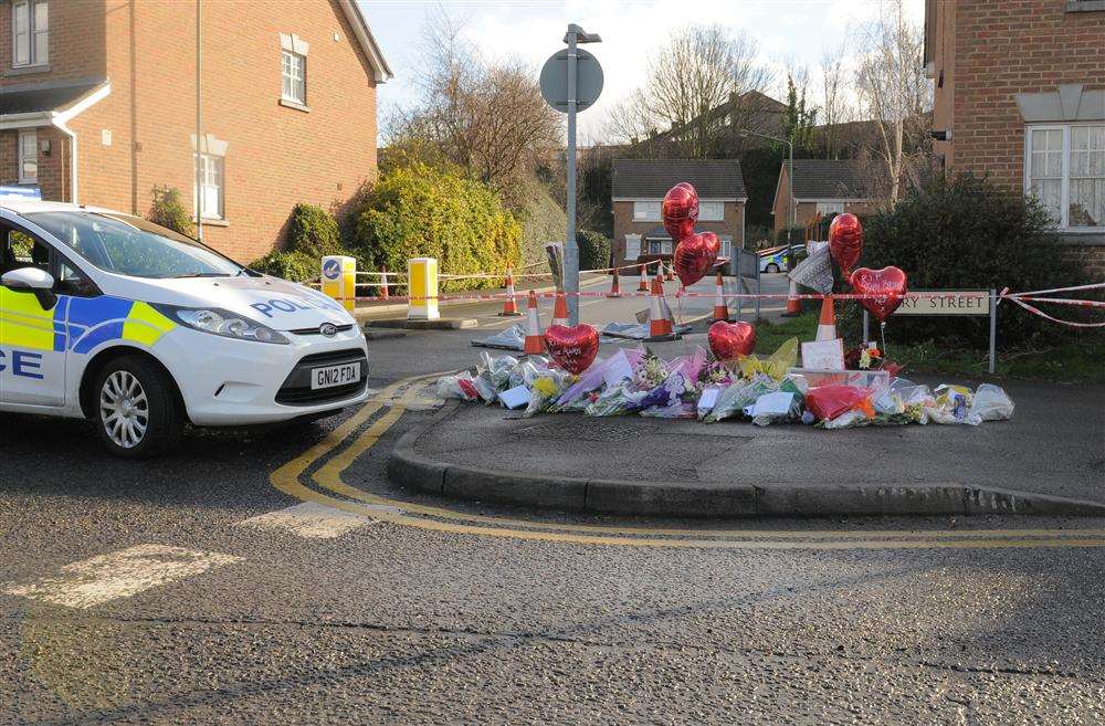 A police car close to the spot where Kevin McKinley was shot in Dartford - where floral tributes were laid