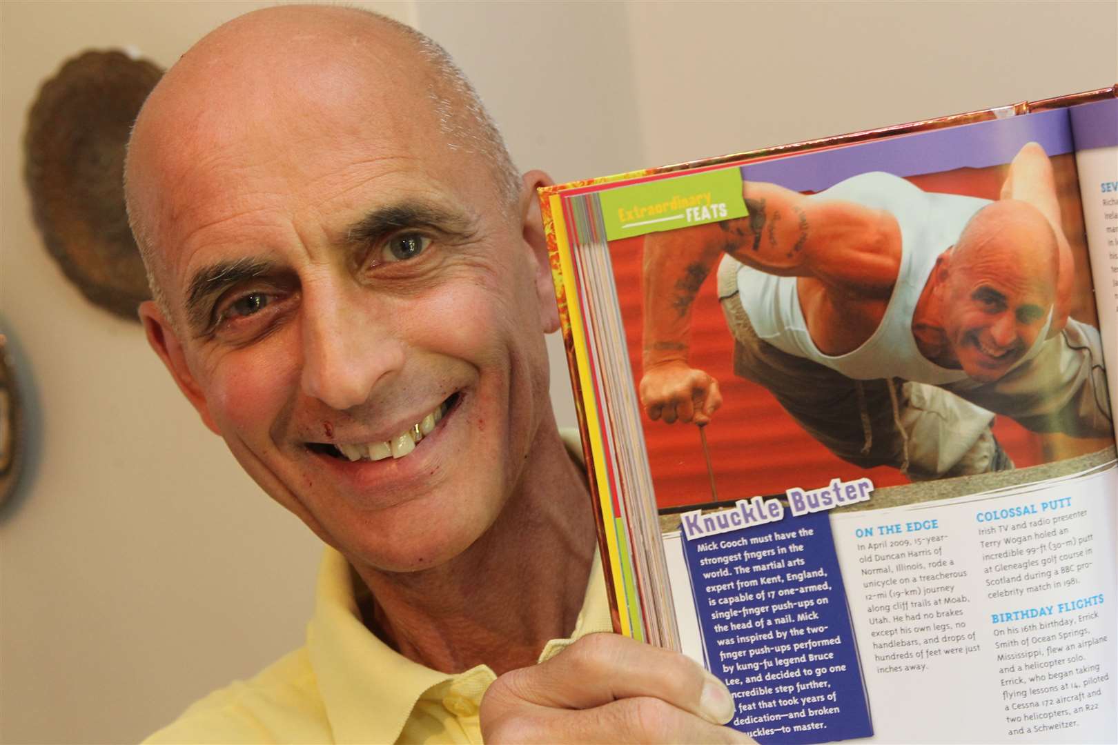 Mick Gooch, shows a picture of himself from Ripley's Believe it or Not, doing a one finger press up on a nail. Picture: John Westhrop (15691528)