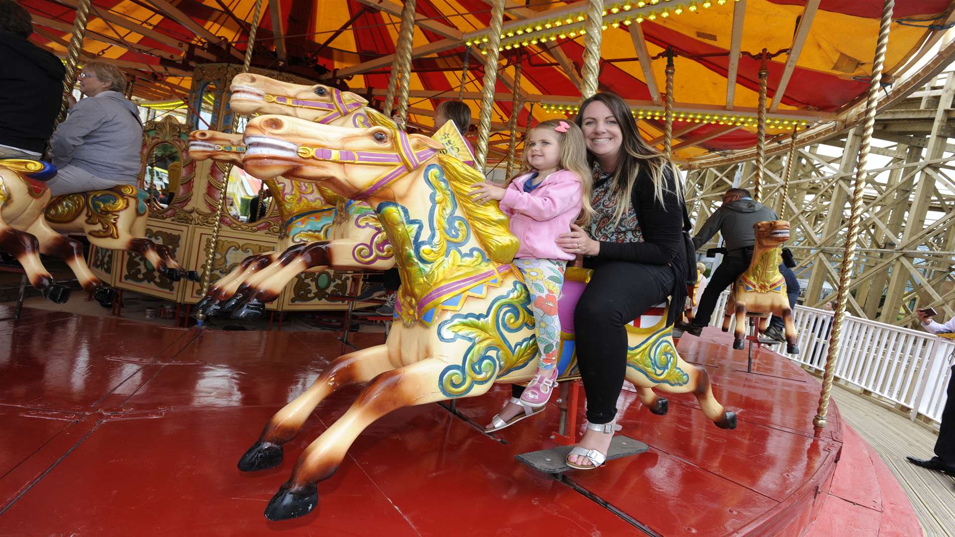 Three year old Grace with mum Karen about to enjoy the first ride of the day. Picture: Tony Flashman