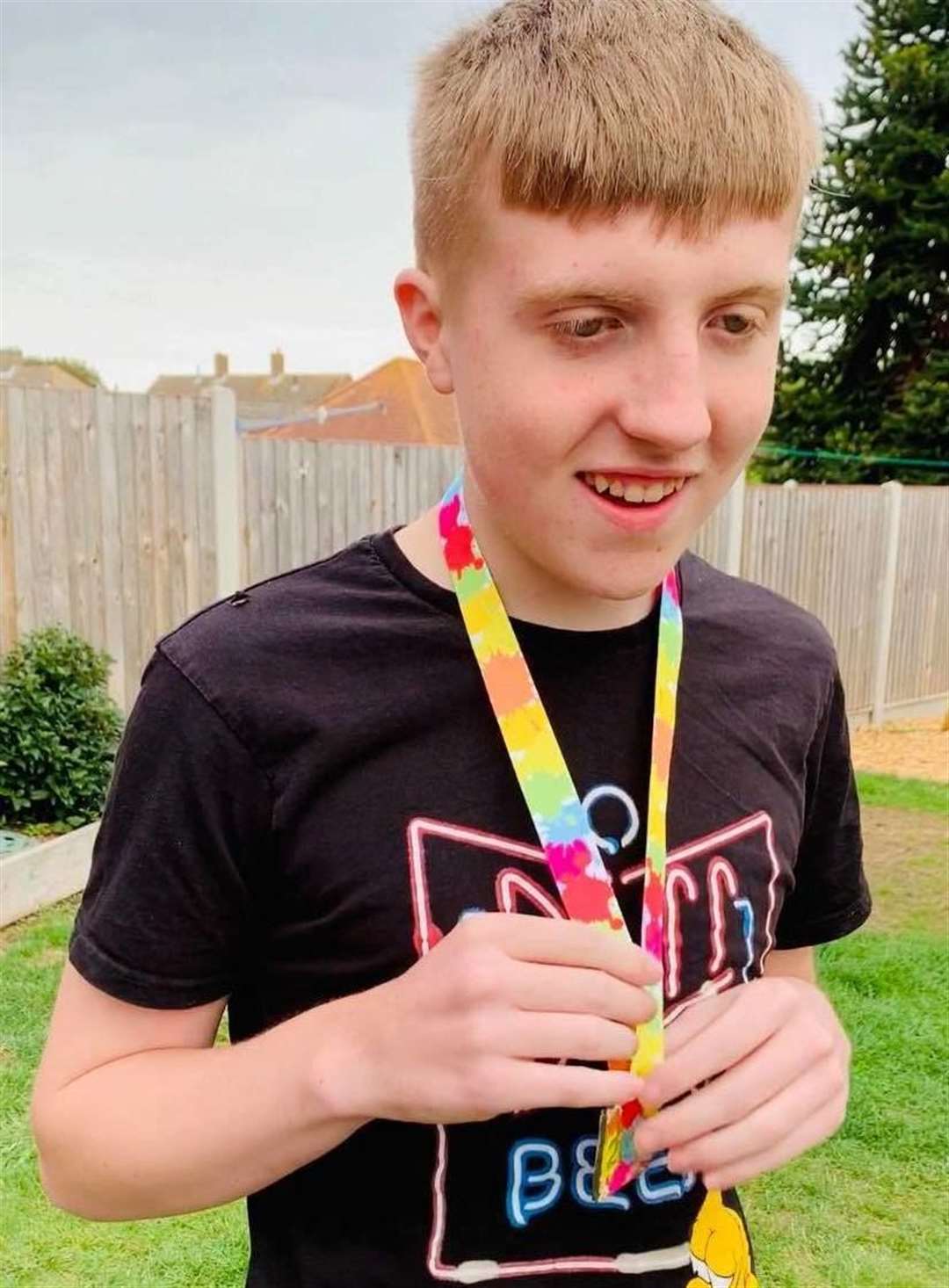 Ryan Buggins with a medal to recognise his achievement