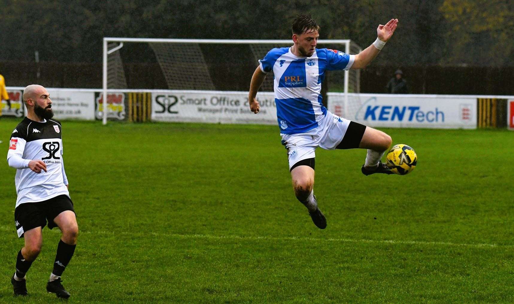 Faversham frontman Frankie Sawyer closes in on Sheppey player Tom Hanfrey. Picture: Marc Richards