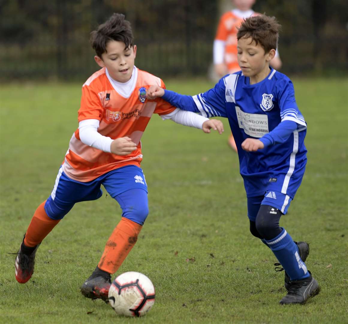 Cuxton 1991 under-10s look to get the better of New Road under-10s (blue). Picture: Barry Goodwin (42745156)