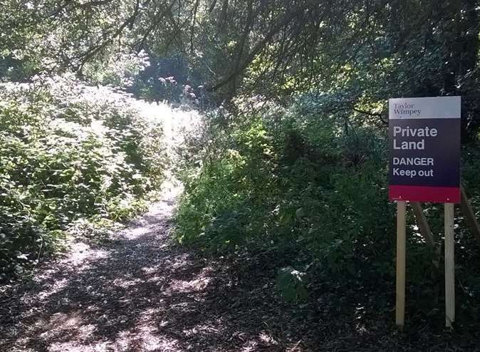 The Taylor Wimpey sign in area near military cemetery and Napoleonic Redoubt