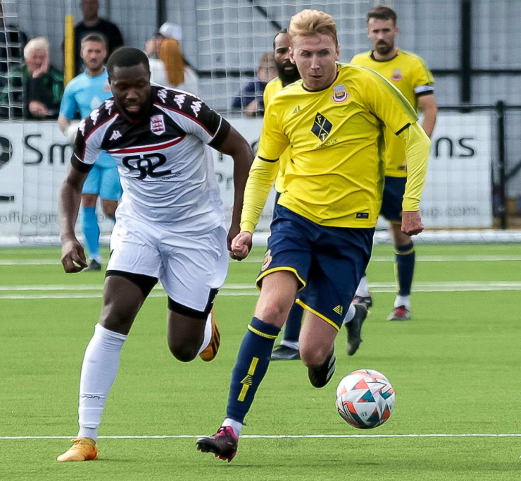 Whitstable’s Harry Gamble breaks away as Faversham's Mo Kamara gives chase during their 2-1 defeat on Monday. Picture: Les Biggs