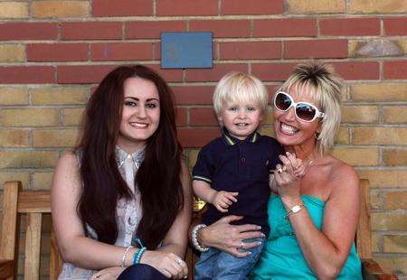 Becca King, Blake King and Karen King sitting on Brett's Bench