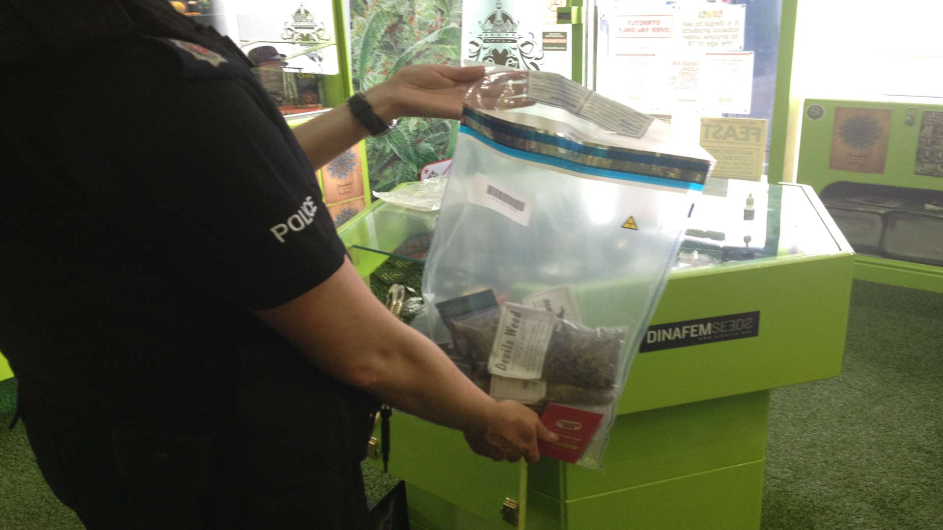 A police officer with a bag of seized products