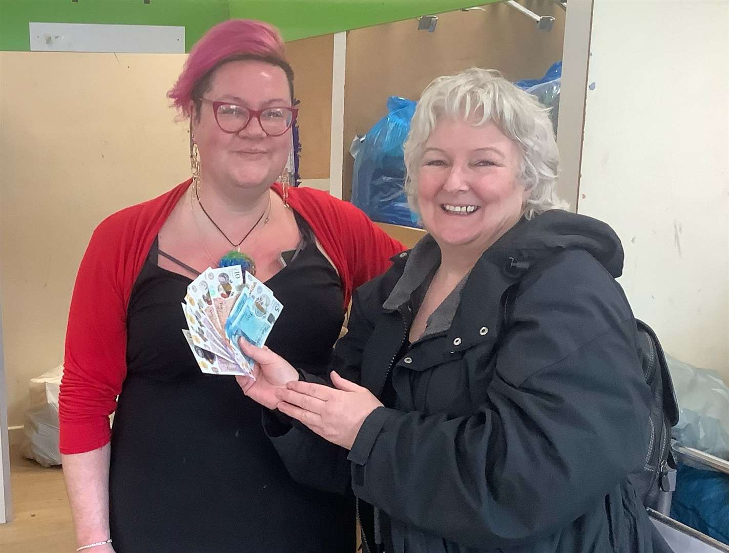 Barnardo’s store manager Sophie Denne, left, accepting the £110 donation from customer Jan D’Arcy