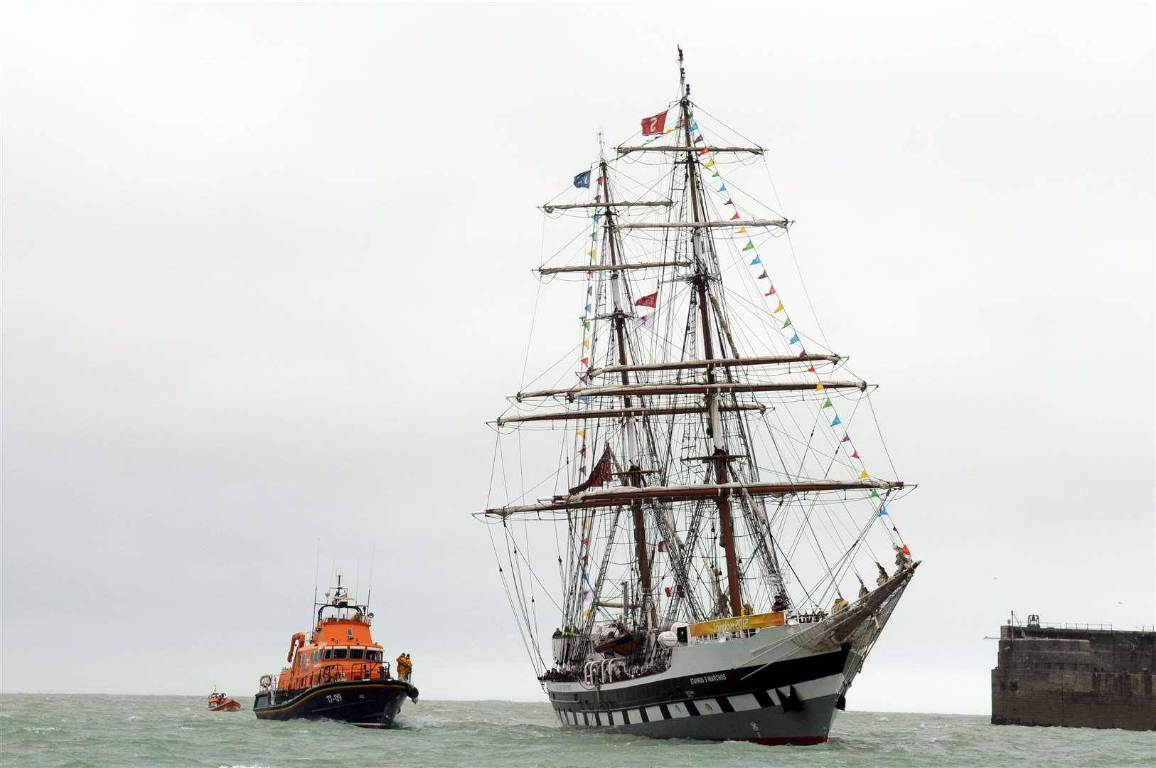 The Olympic torch relay arrives in Dover harbour on the Stavros ship before it is transferred onto a lifeboat