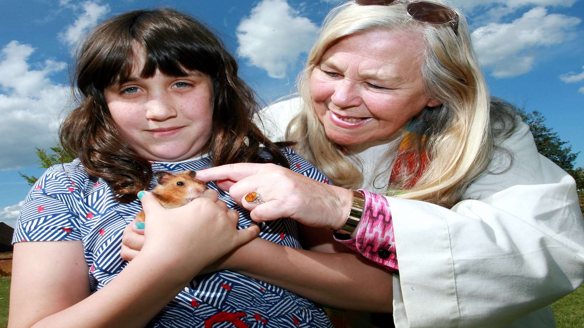 Caitlin Underwood with her pet hamster Alice, with the Rev Cindy Kent