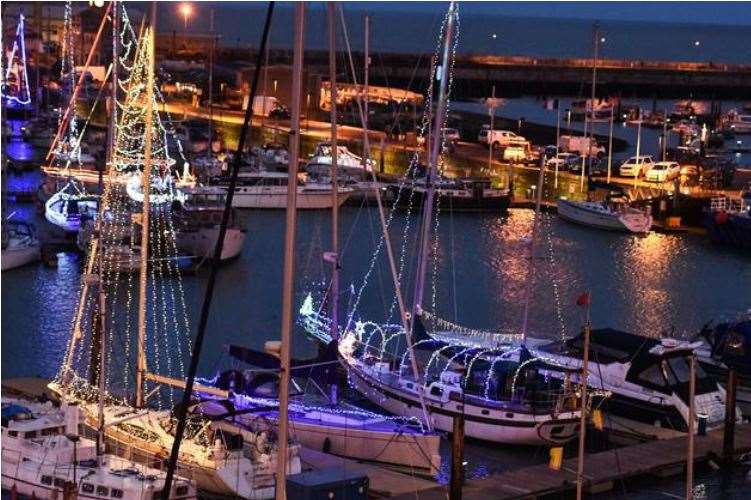 Boats in the harbour and marina in Ramsgate lit up with Christmas lights