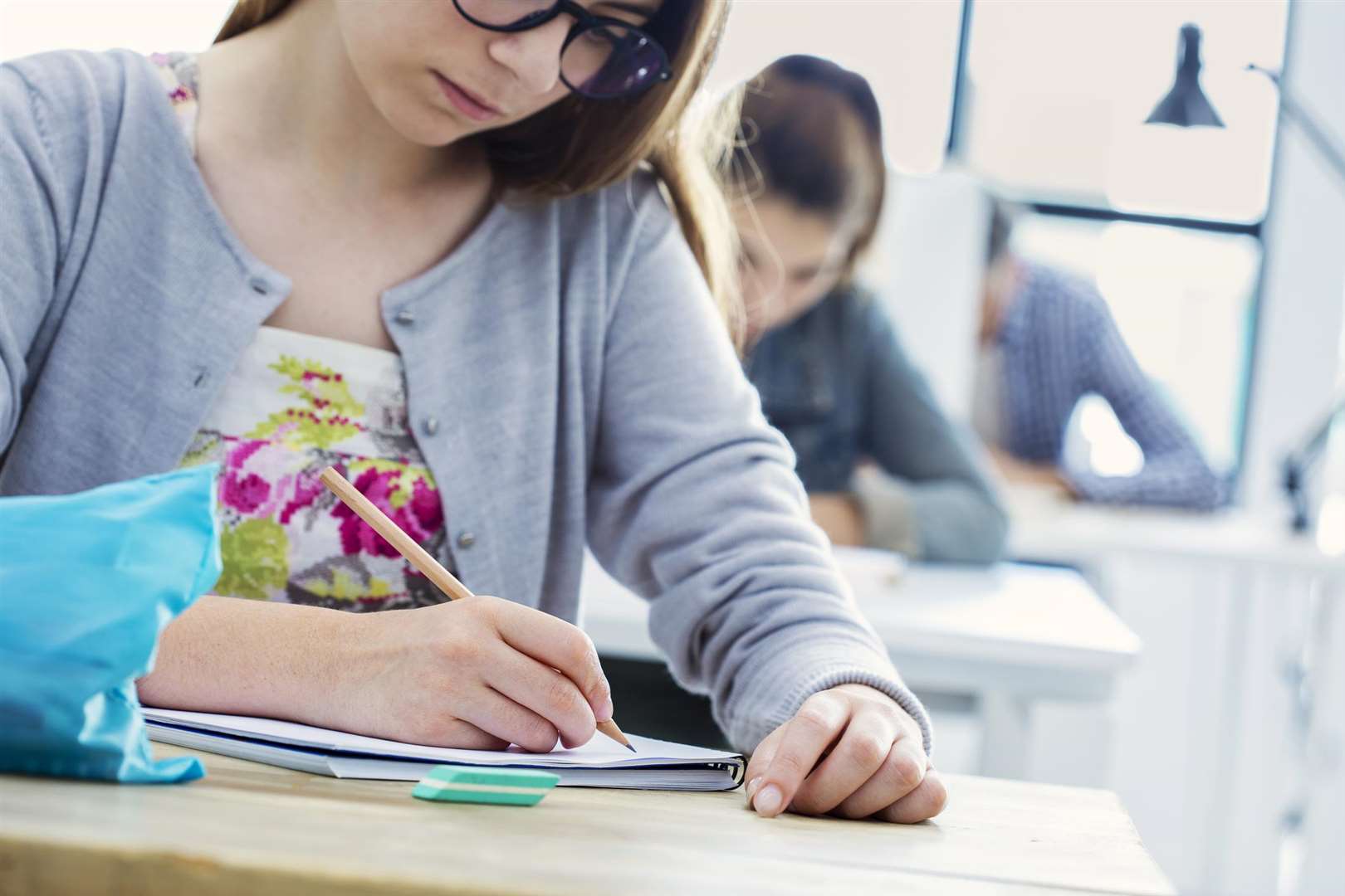 Student girl writing test in classroom