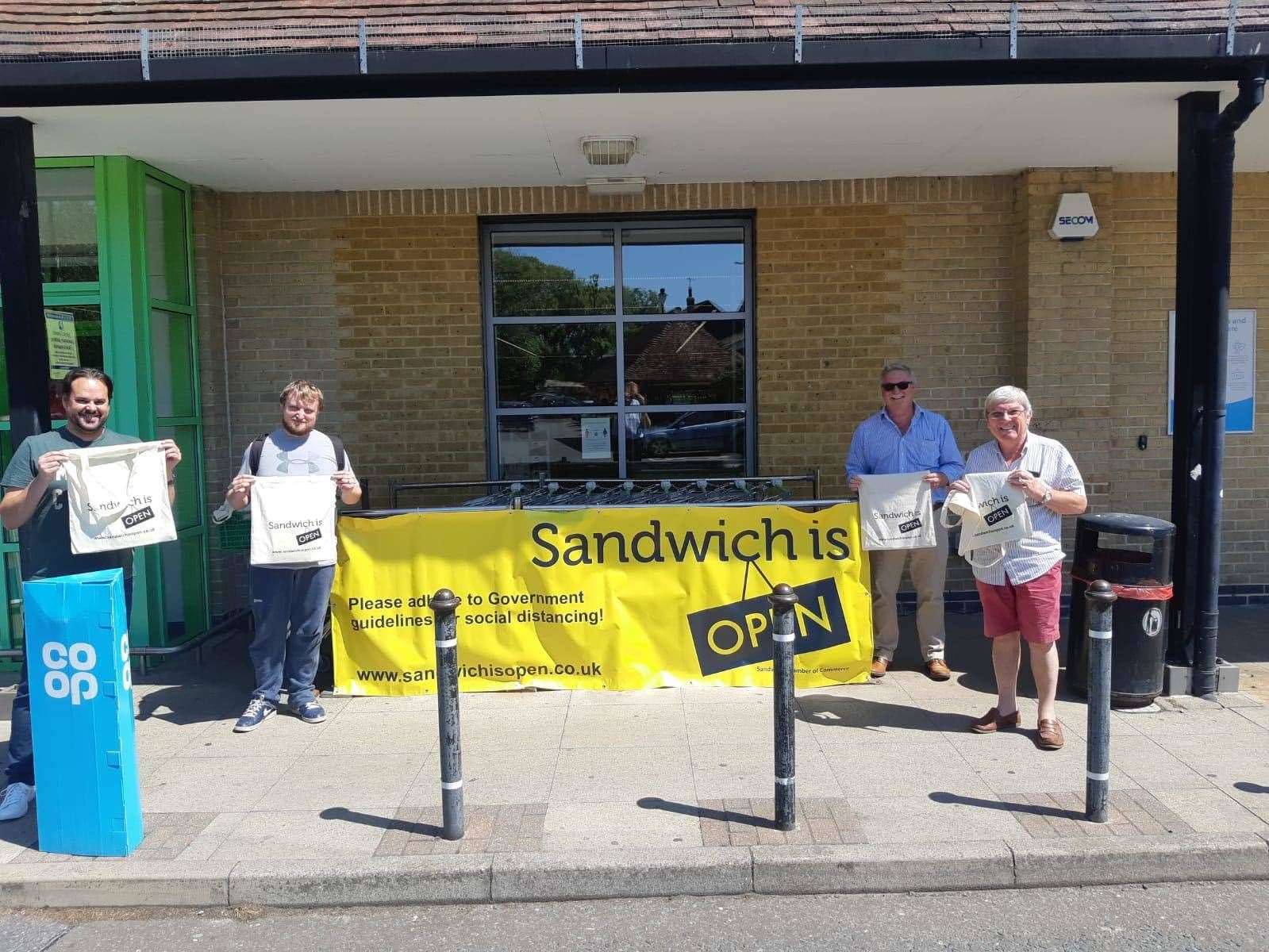 The Chamber of Commerce president Paul Graeme is joined by vice chairman Steven Ruston, chairman David Shaw and vice president Dan Friend to hand out the packs