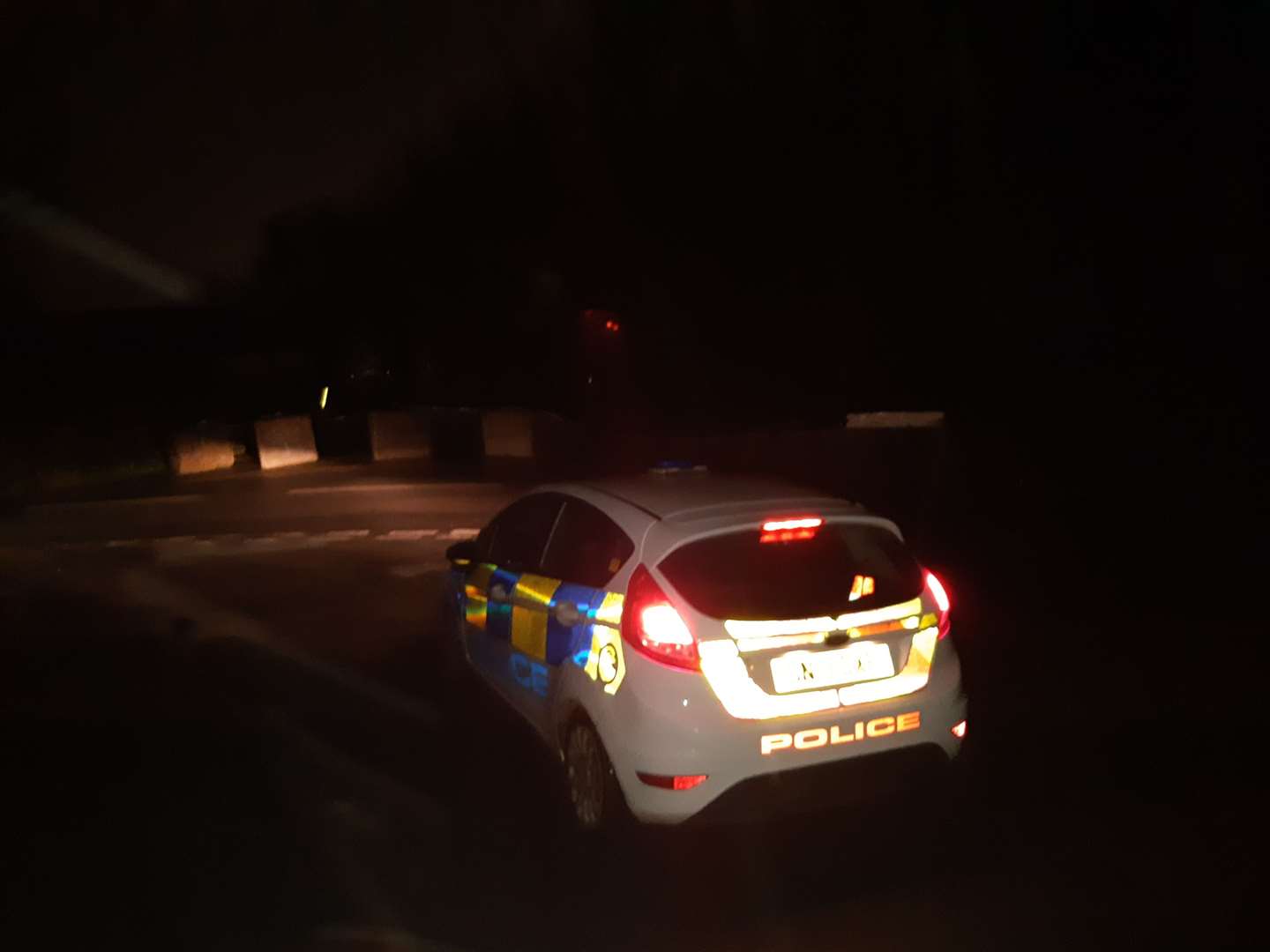 A police car parked outside the garage in Dover