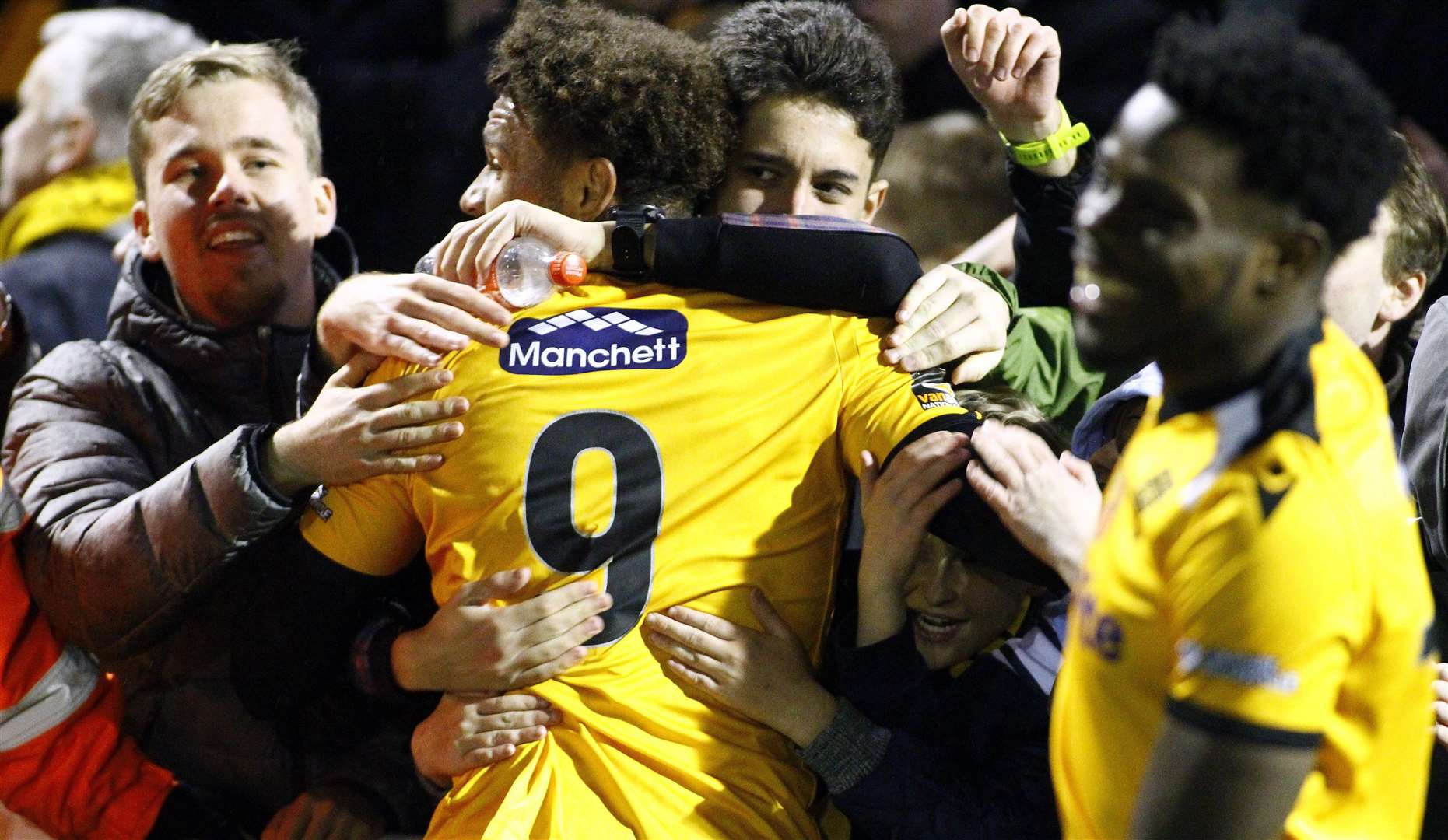 Maidstone United fans celebrate with the players at the final whistle on Saturday Picture: Sean Aidan