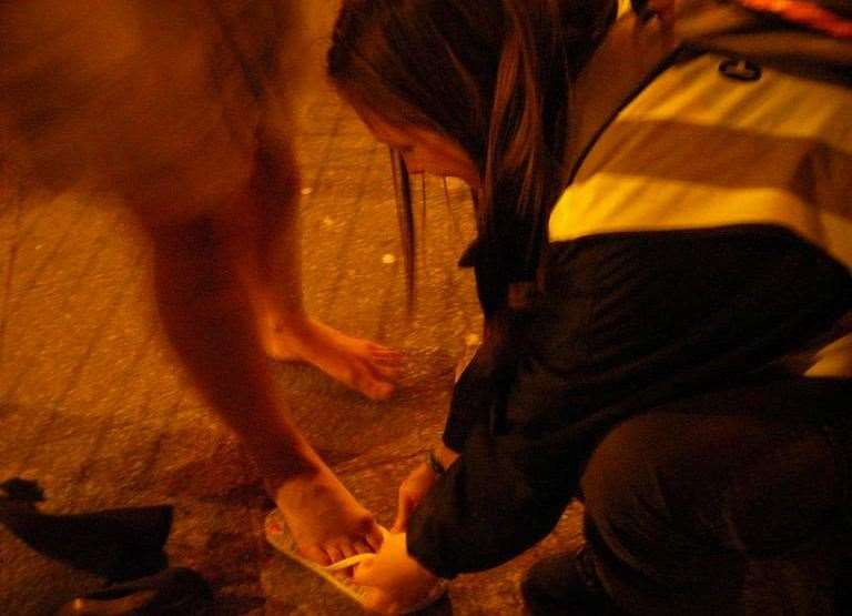 The 'flip flop brigade' equipping a reveller with free footwear. Picture: Community Pastors